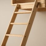 Close-up of a wooden loft ladder leading up to a storage space